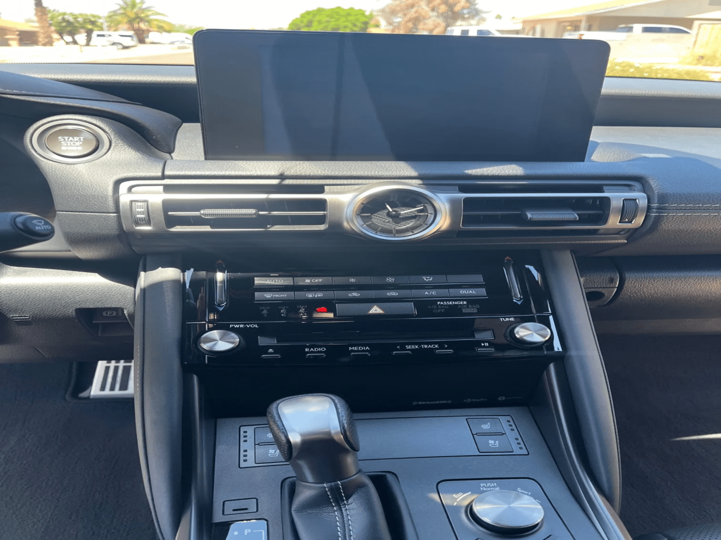 A car dashboard with the radio and other items in it.