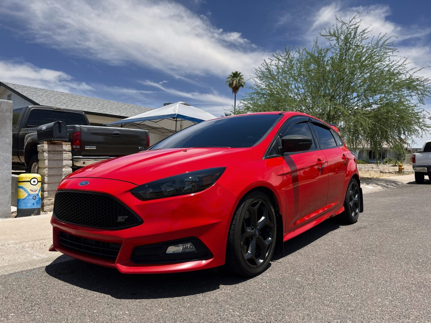 A red car parked on the side of a road.